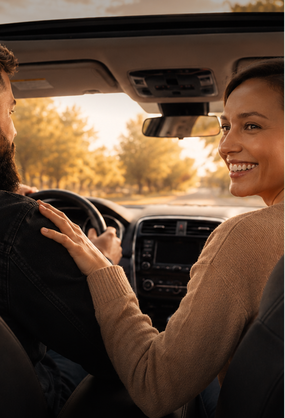 Passenger smiling while riding in a car