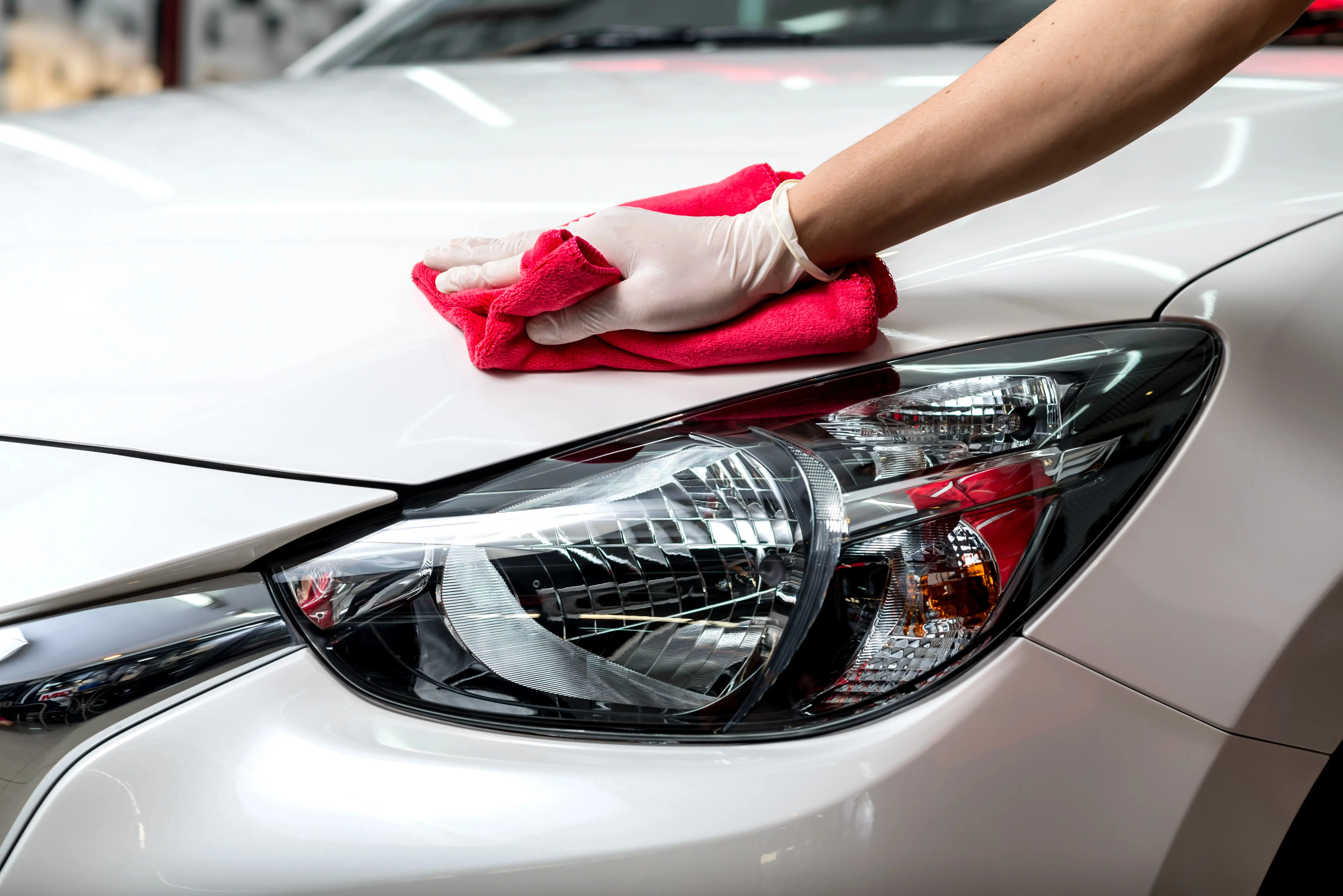 Hand wiping car with cloth