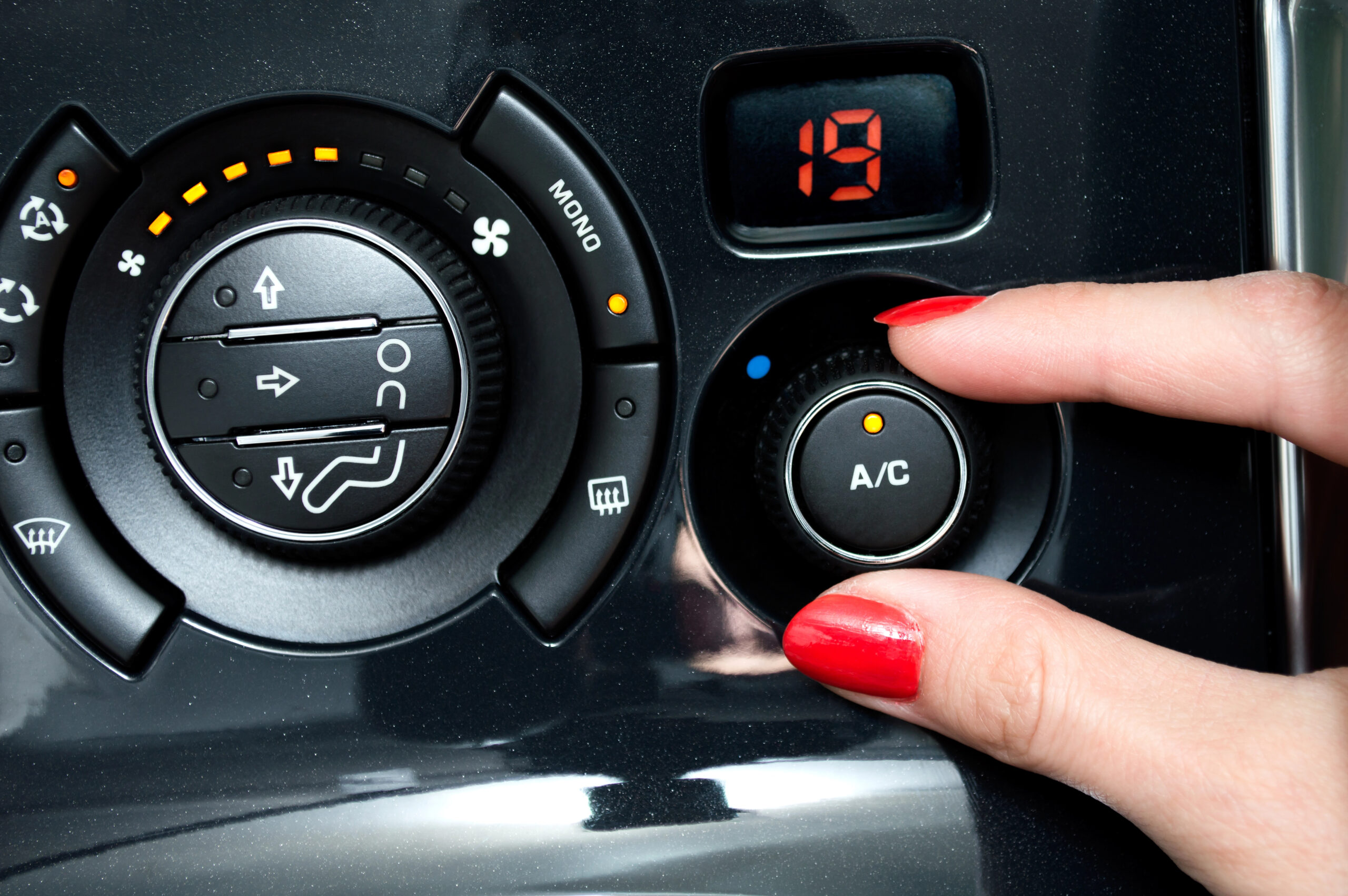 person turning on car AC