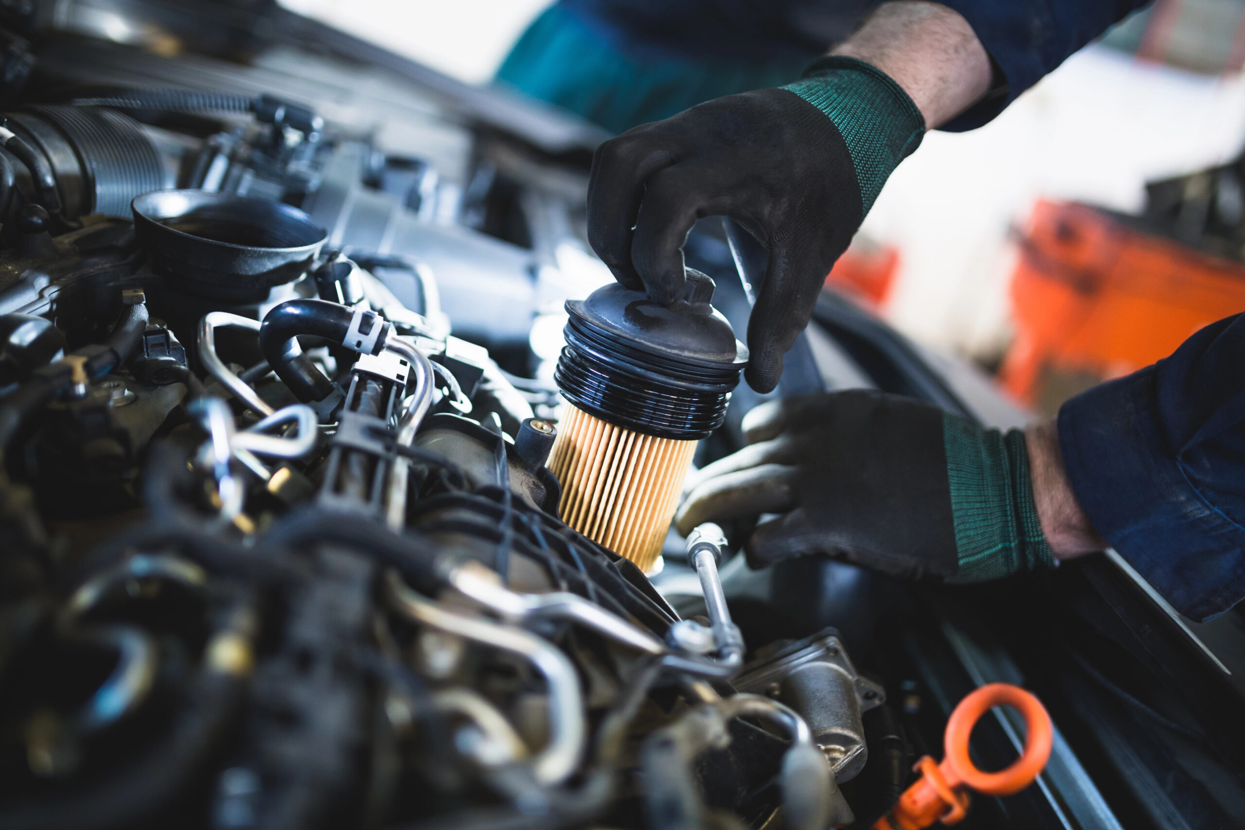 Mechanic installing car oil filter