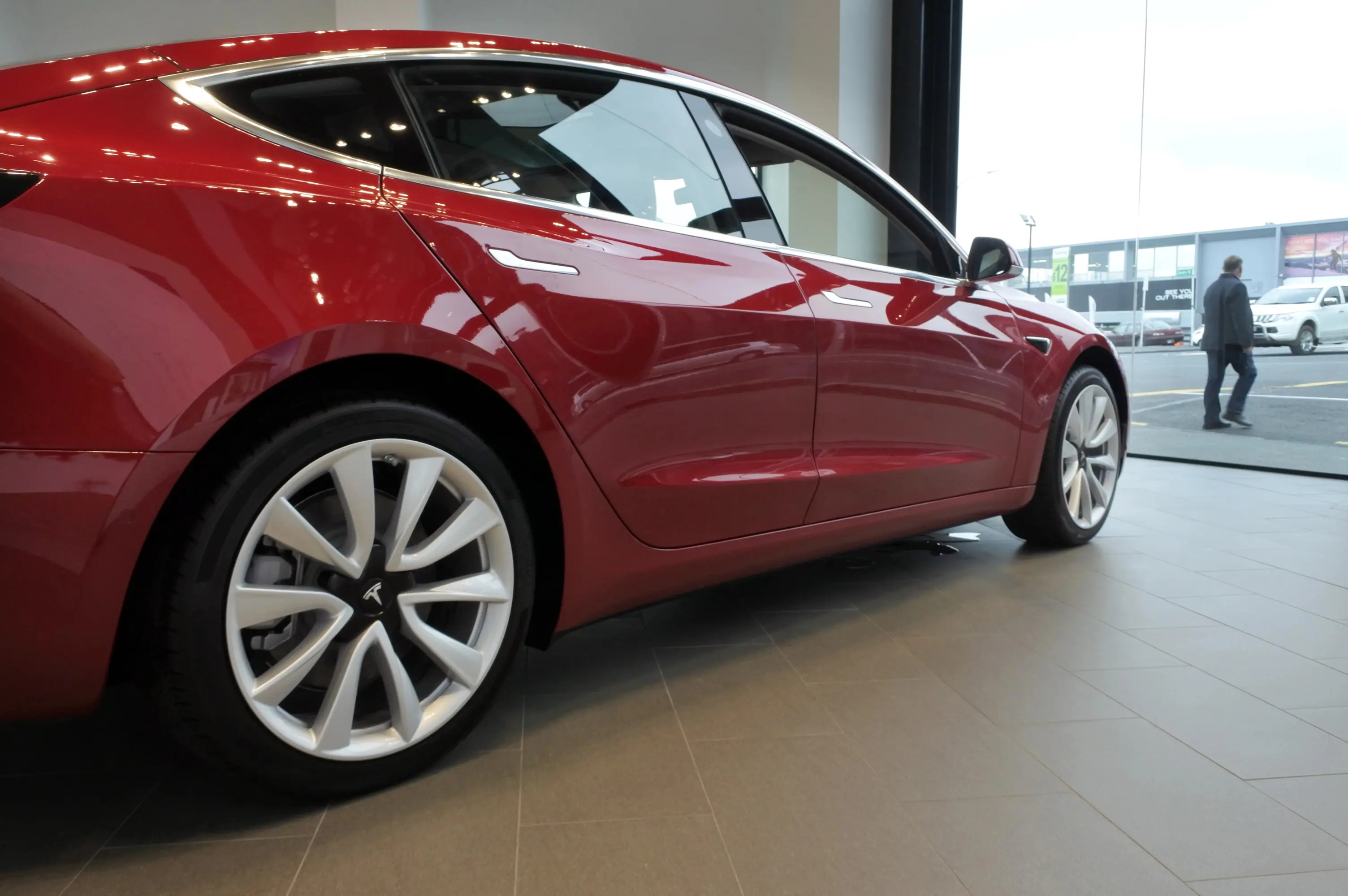 Sideview of a red Tesla in a garage