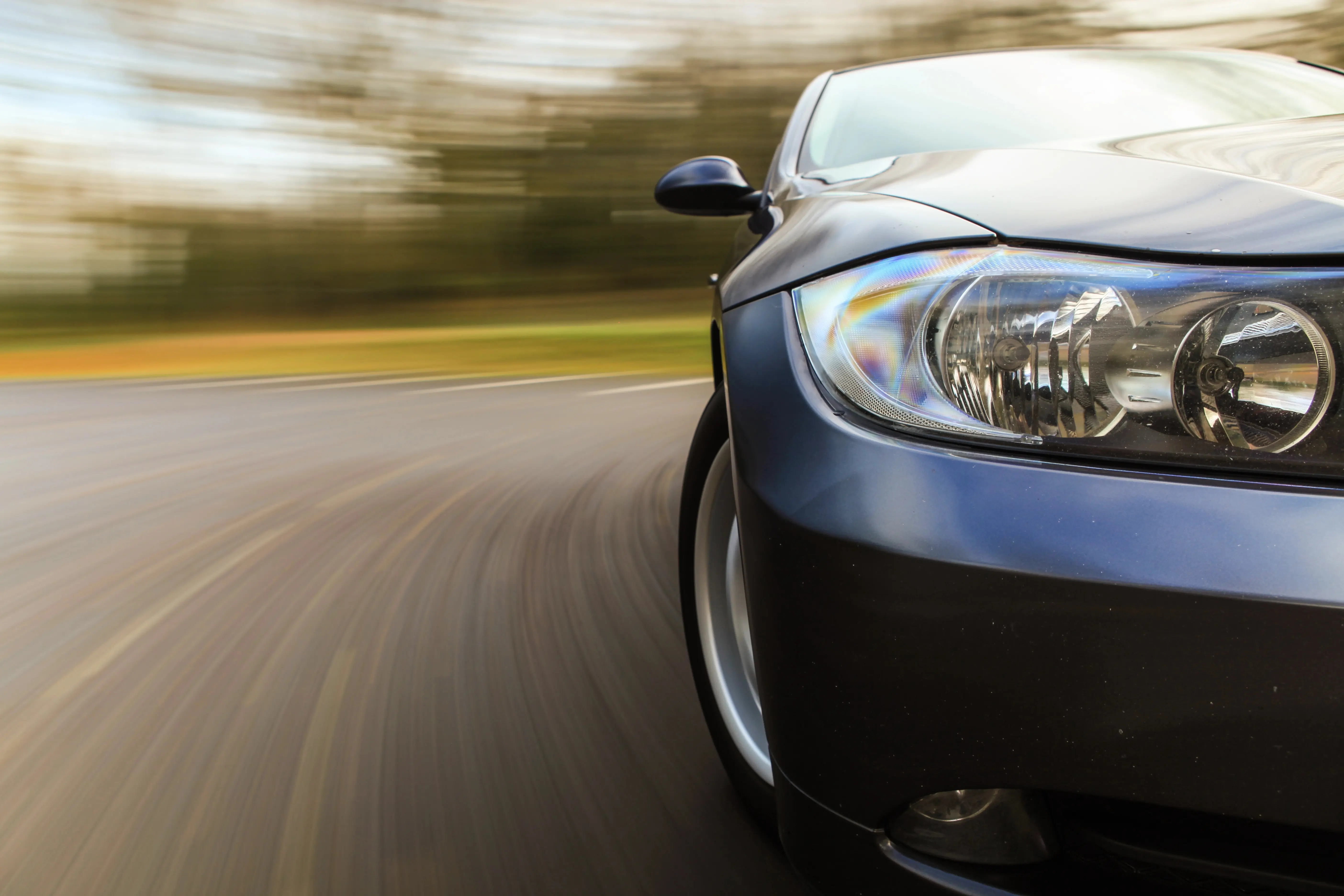 Up close of blue car speeding