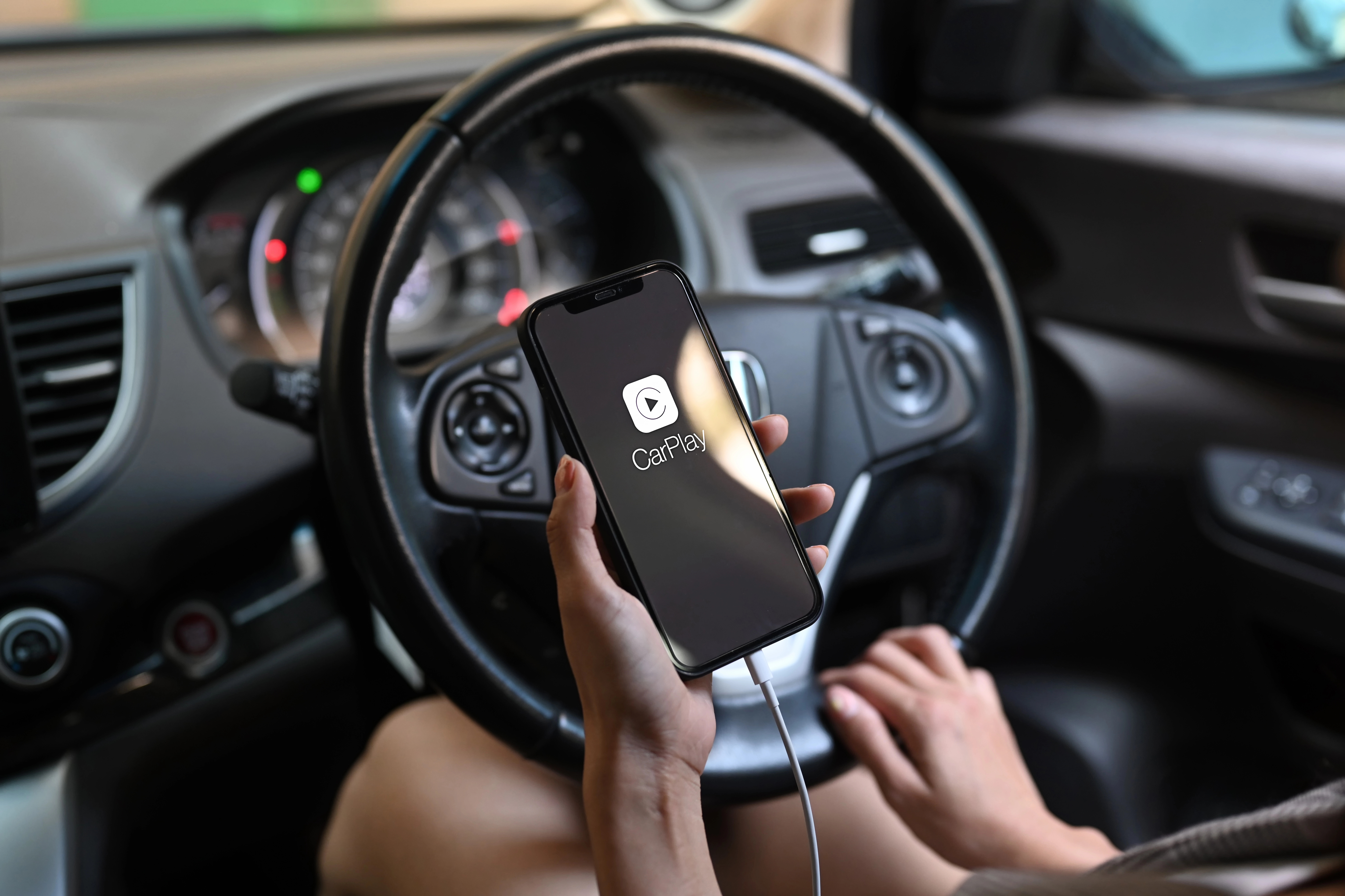 Person connecting phone to media console in car