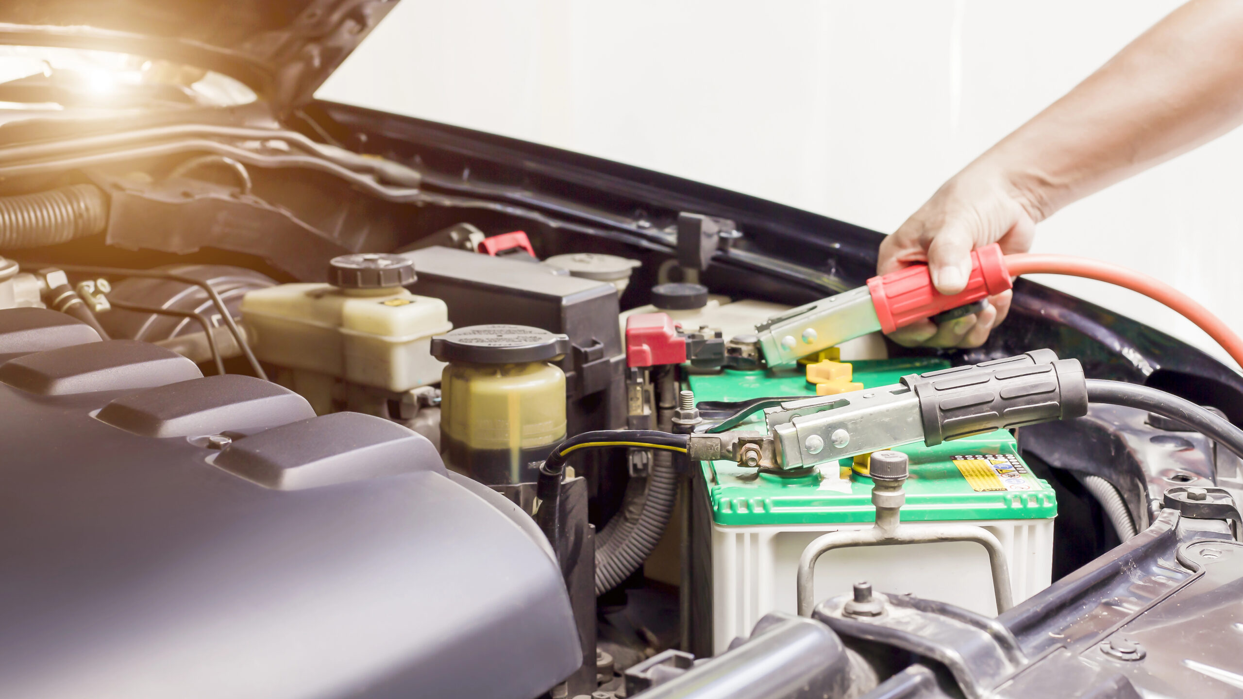 Close-up of someone jumpstarting a car