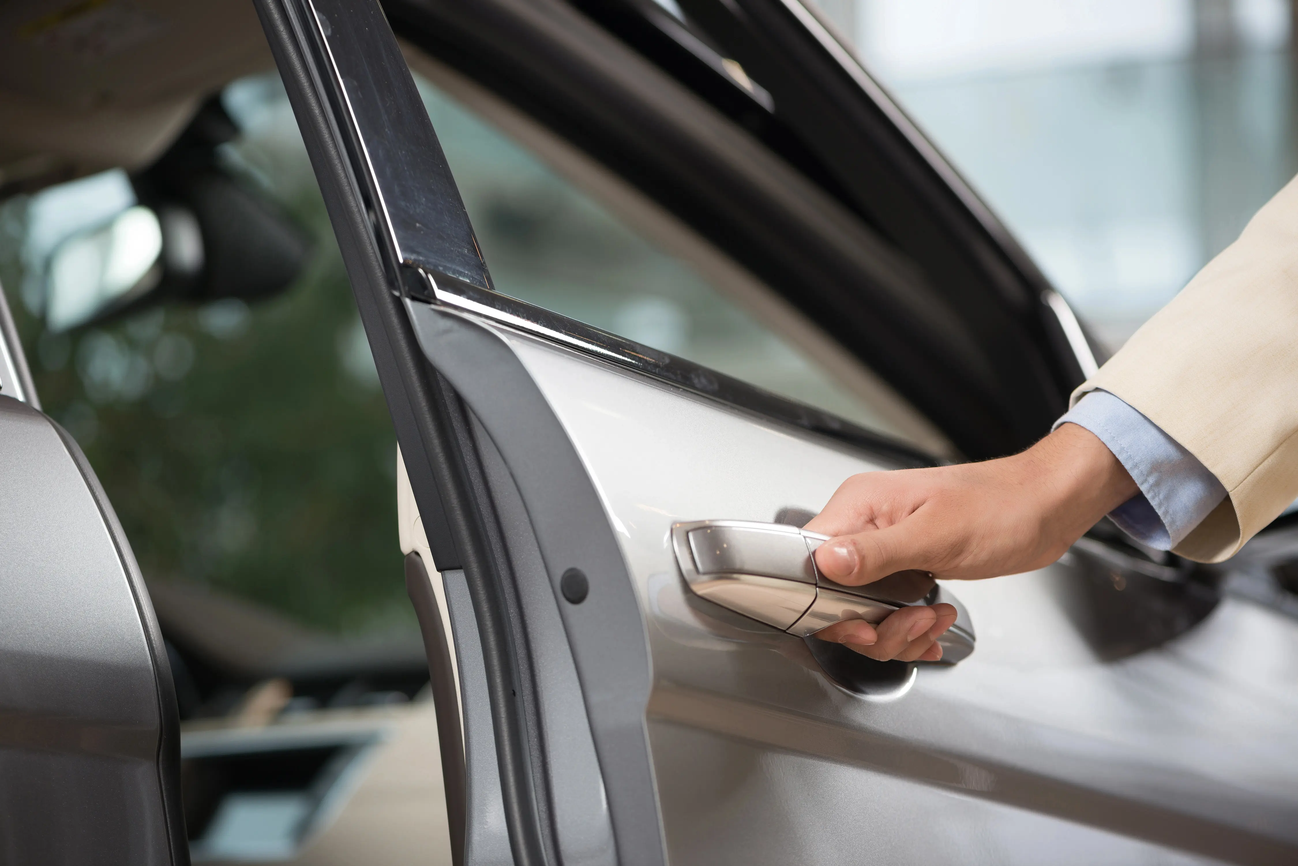 man opening passenger door on car
