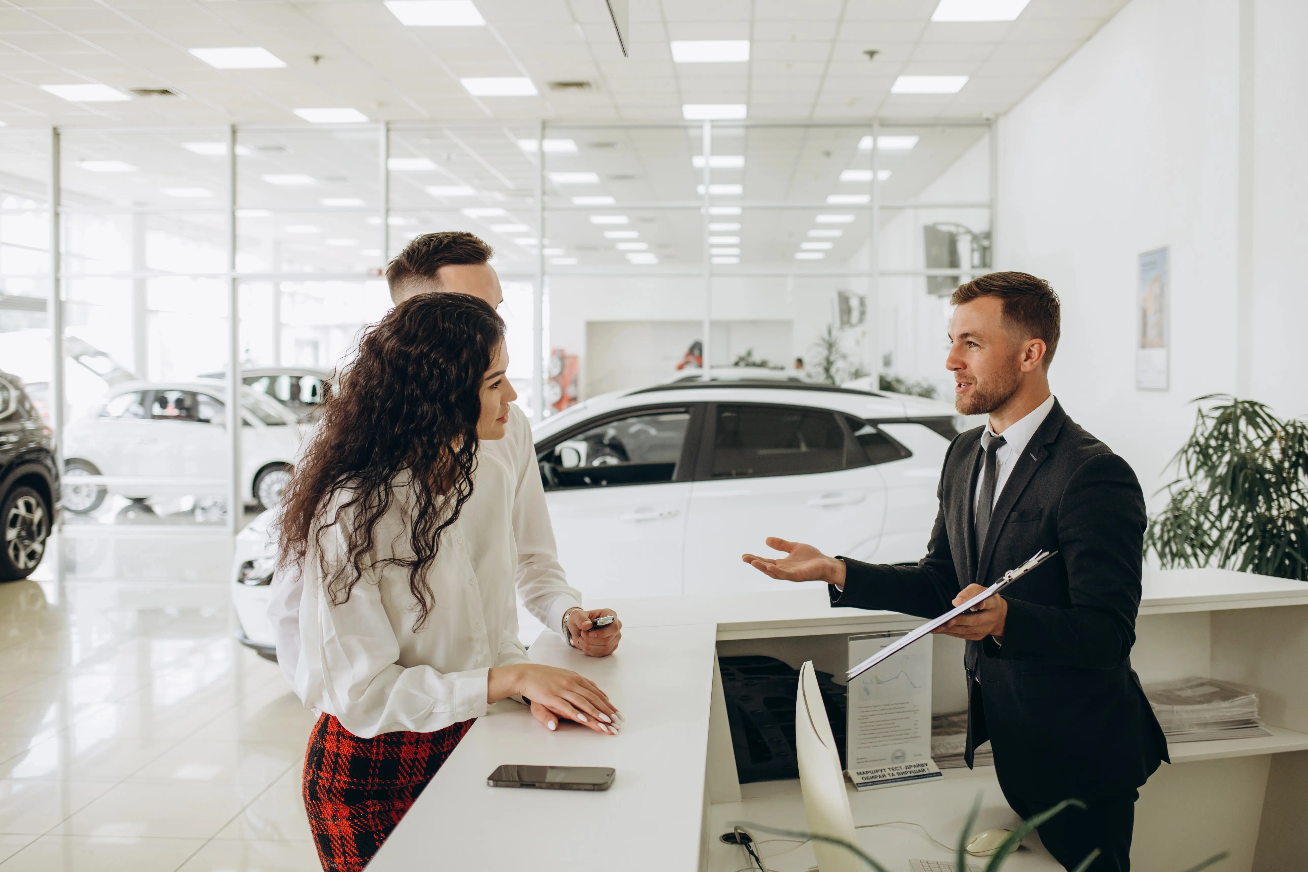 Car salesman at desk