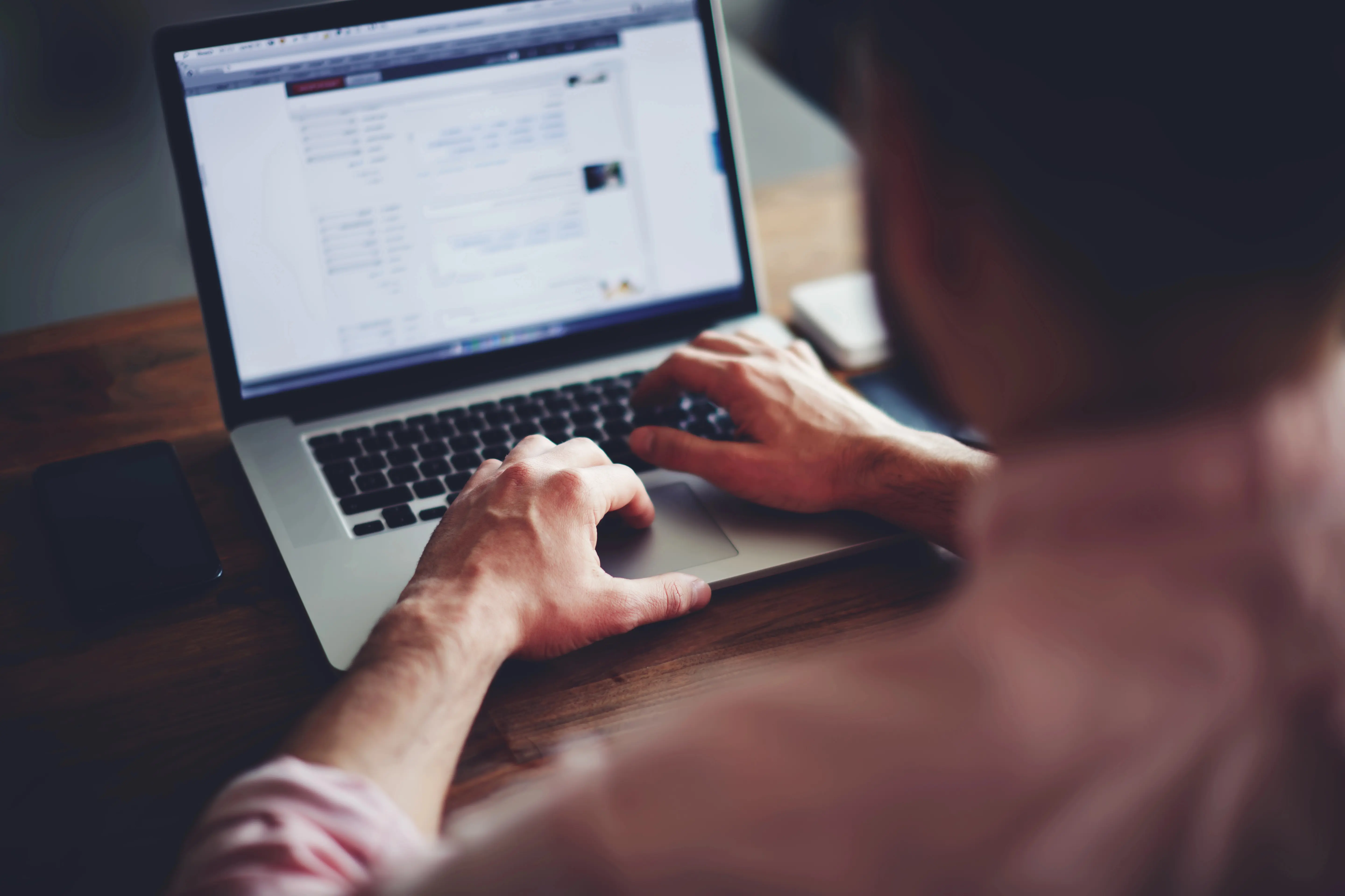 Back view of a person on laptop
