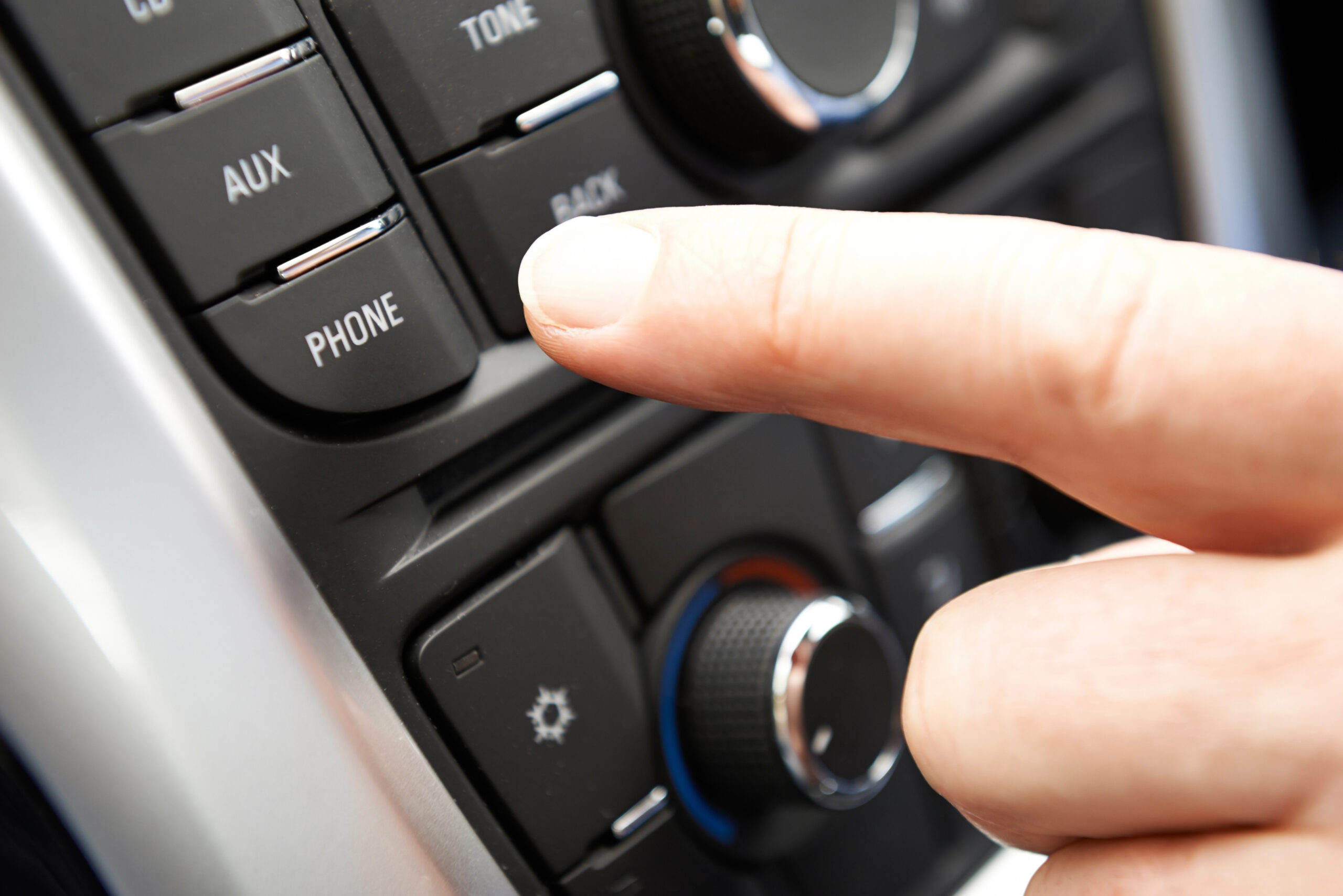 Close up of hand touching bluetooth on media console
