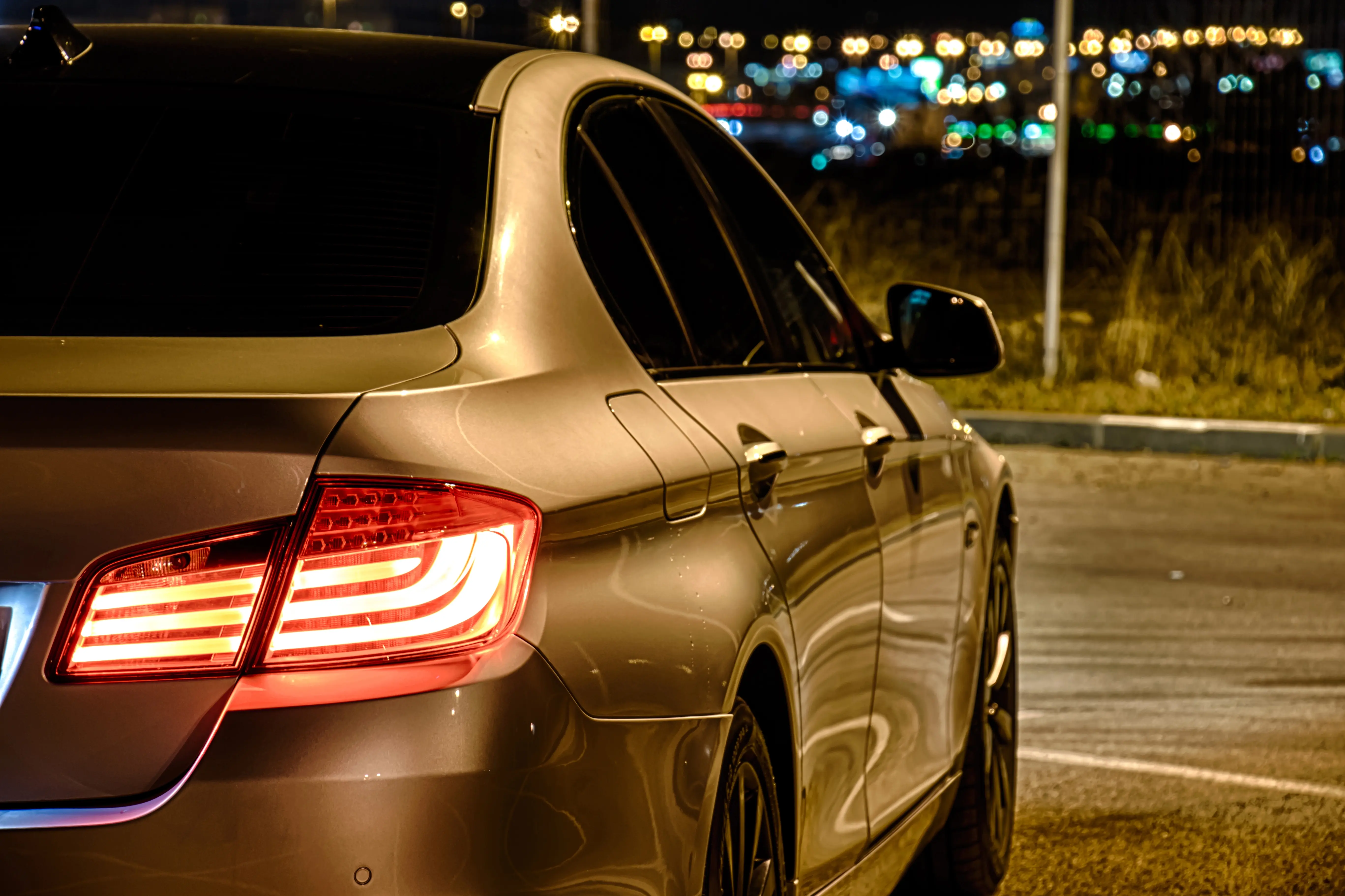 Silver car parked at night.