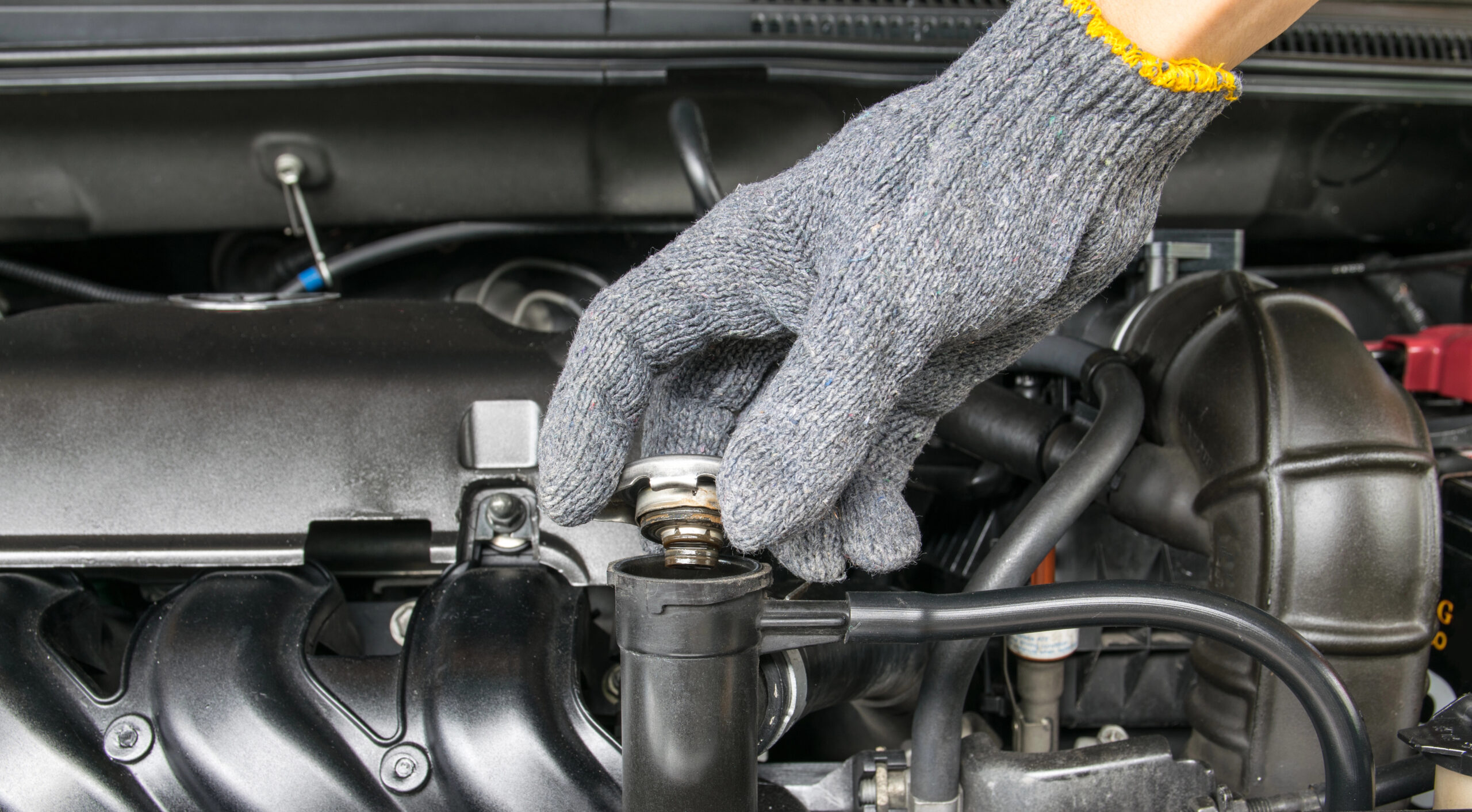 Close up of hand fixing car radiator