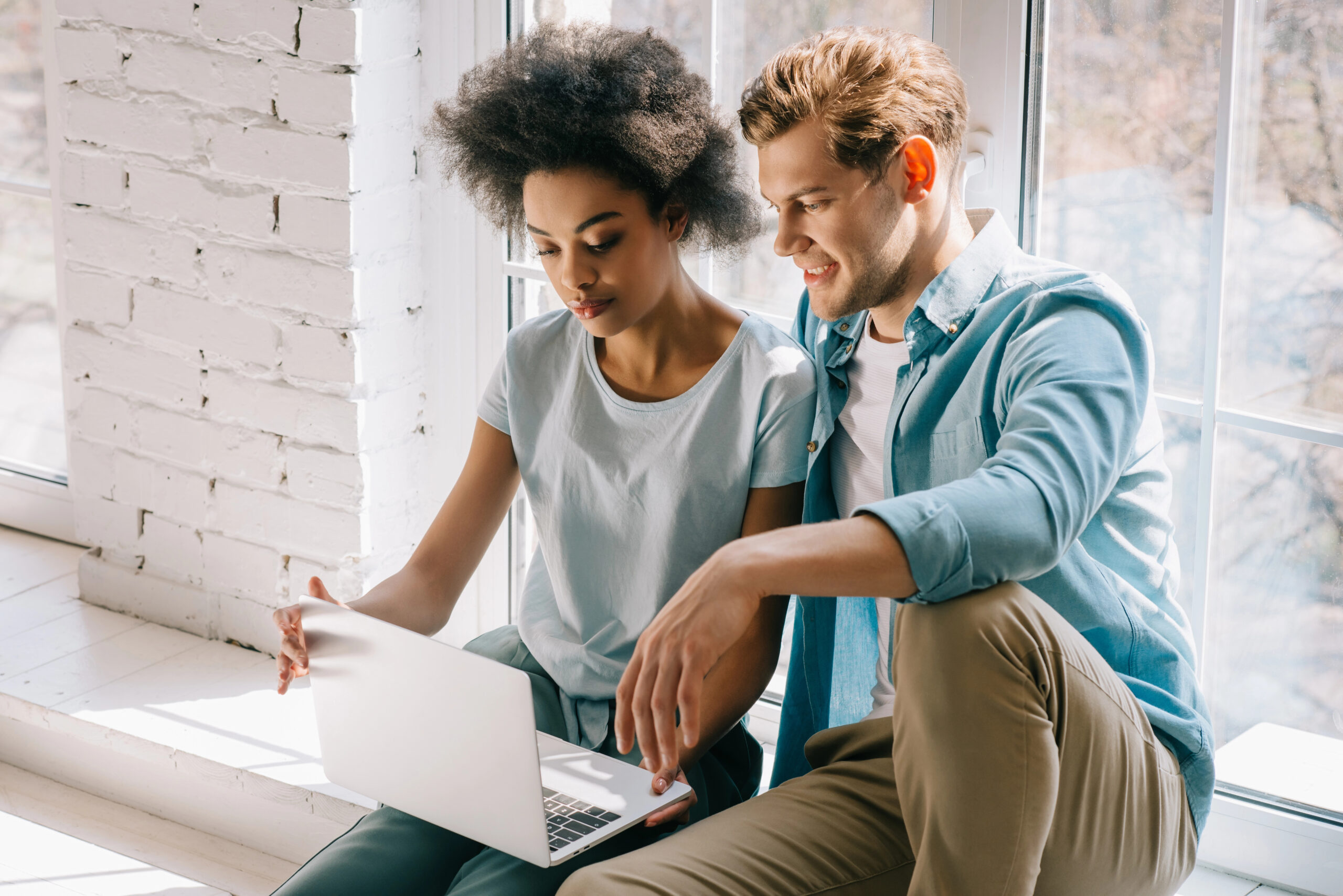 Woman and man looking at laptop.